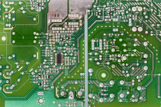 Fragment of printed circuit assembly with electronic components closeup 

