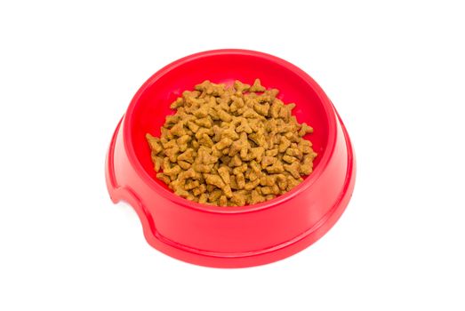 Pelleted dry cat food in a red plastic bowl on a light background
