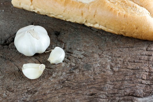 Garlic cloves on a vintage wooden background.