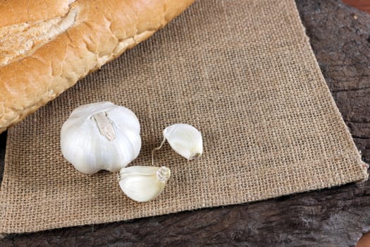 Garlic cloves on a vintage wooden background.