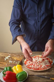 Man makes homemade pizza vertical