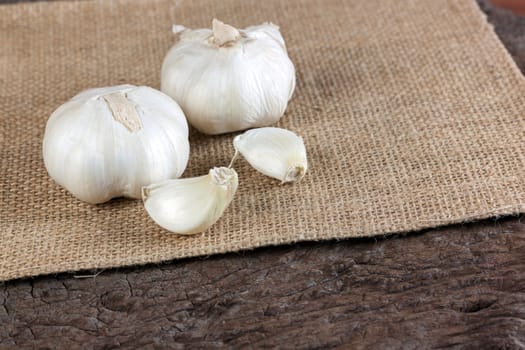 Garlic cloves on a vintage wooden background.