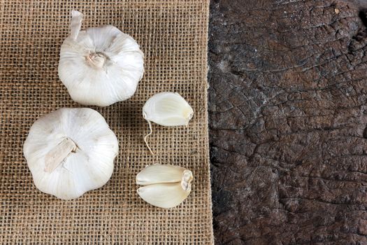 Garlic cloves on a vintage wooden background.