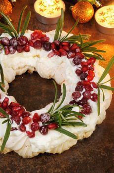  Christmas wreath made of meringue with cream, pomegranate, cranberry, rosemary  