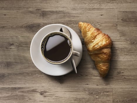 Coffee cup and fresh baked croissants on wooden background. Top View