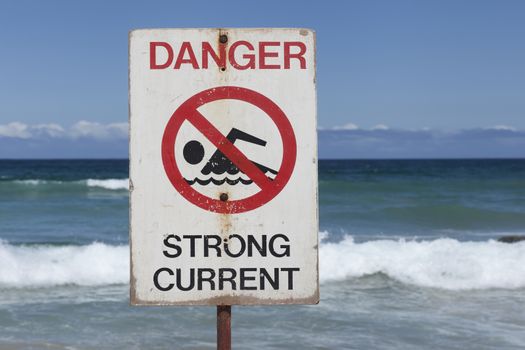 Dangerous currents sign at Bondi Beach in Sydney, Australia. On a sunny day