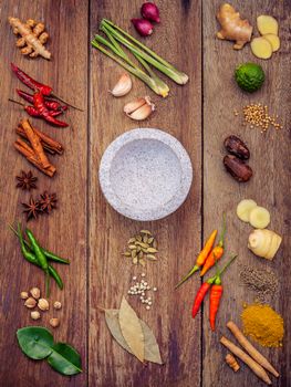 Various of Thai food Cooking ingredients and spice red curry paste ingredient of thai popular food on rustic wooden background. Spices ingredients chilli ,pepper, garlic nutmeg and Kaffir lime leaves.