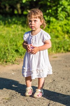 a little girl walks in the Park in summer