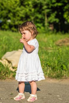 a little girl walks in the Park in summer