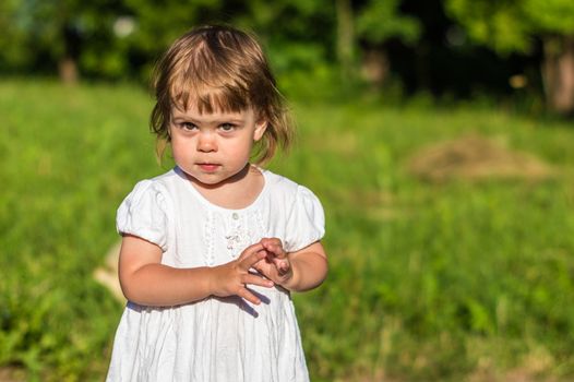 a little girl walks in the Park in summer