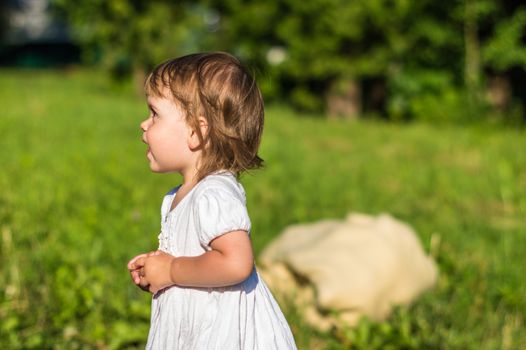 a little girl walks in the Park in summer