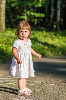 a little girl walks in the Park in summer