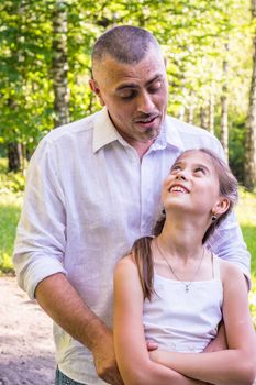 Daddy hugs his daughter in the Park