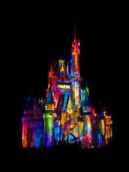 Disney castle beautifully lit with colors