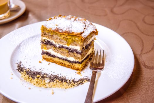 Exquisite sweet dessert, a traditional cake from Prekmurje with poppy seeds, nuts, cottage cheese and apple layers, called Prekmurska gibanica.