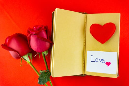 Valentines notebook with message card on red background. Image of Valentines day.