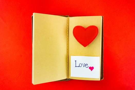 Valentines notebook with message card on red background. Image of Valentines day.