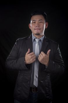 portrait of younger asian business man good working hand sign with studio lighting 