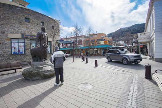 QUEENTOWN NEW ZEALAND-SEPTEMBER 6:tourist standing and looking to  with william gilbert rees statue in queen town on september 6 , 2015 in New Zealand