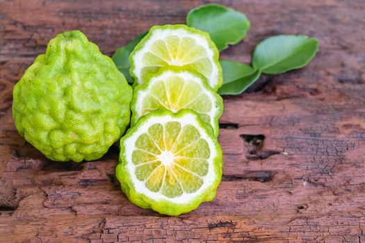 Bergamot on old wooden tables background.