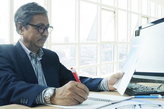 senior business man working on office table