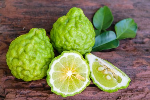 Bergamot on old wooden tables background.