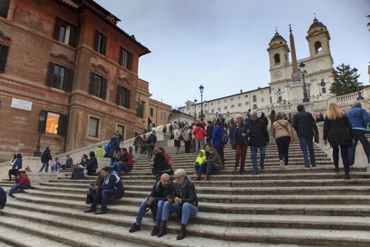 ROME ITALY - NOVEMBER 8 : large number of tourist sitting in front of spanish step fountain important traveling landmark and shopping point on november 8, 2016 in rome italy