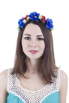 Portrait of a girl in a wreath of flowers on a white background