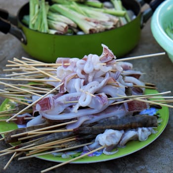 Vietnamese food for weekend party of family at home, cuttlefish and shrimp skewer to grill, delicious seafood