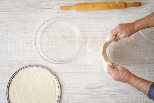 Cooking pizza dough on the table horizontal