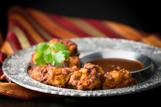 Indian vegetable pakoras served with a tamarind dipping sauce.