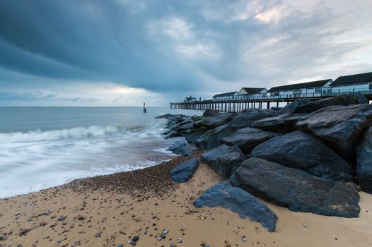 Rocks in the fireground, on the beach, next to Southwold Pier, in Suffolk, at sunrise