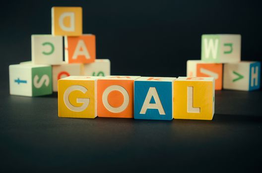GOAL word with colorful blocks. goal reach business team wood block text concept