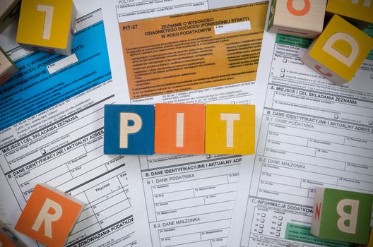 PIT word with colorful blocks. polish tax form money business finance block concept