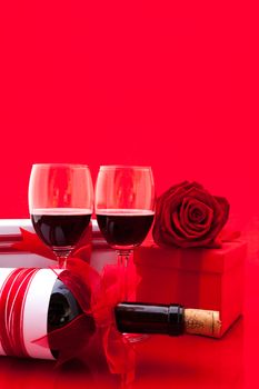 St Valentine's setting with present and red wine.