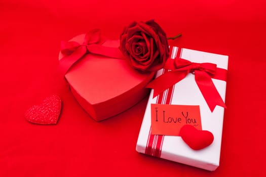 Valentines gift box with a red bow on red background. Image of Valentines day.