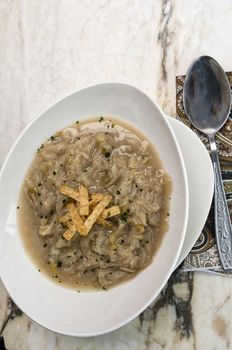 French onion soup with croutons in a white oval modern dish