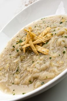 French onion soup with croutons in a white oval modern dish