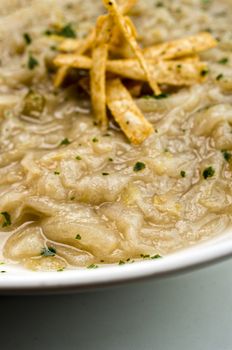 French onion soup with croutons in a white oval modern dish
