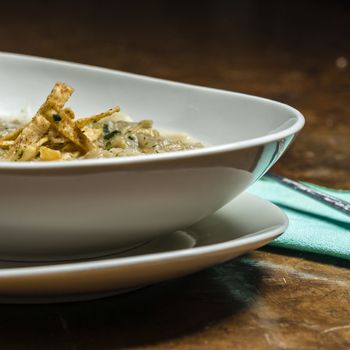 French onion soup with croutons in a white oval modern dish