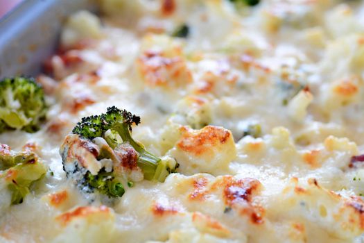 Closeup of baked cauliflower and broccoli with grated parmesan.