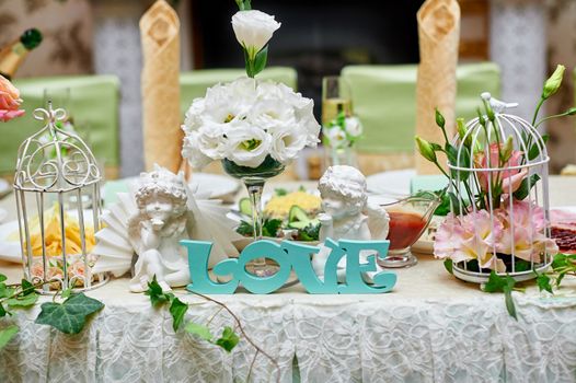 beautiful wedding decorations of flowers on a table in the restaurant.