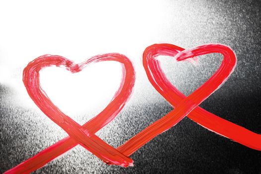 Two abstract red painted hearts on metal background