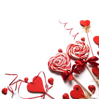 Valentines day decoration and heart shaped lollipops isolated on white background