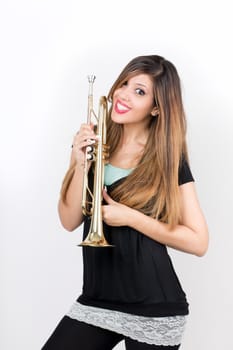 Funny beautiful woman holding trumpet isolated 