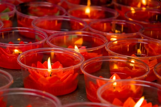 Red lotus shaped candles at chinese buddhist temple