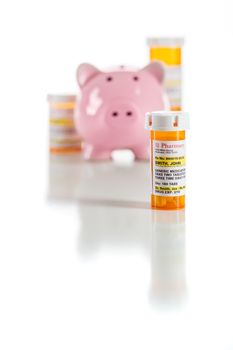 Piggy Bank and Non-Proprietary Medicine Prescription Bottles Isolated on a White Background.