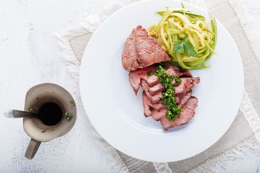 Zucchini pasta and meat served on the table