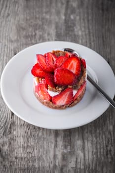 Strawberry and custard tart on a white plate 