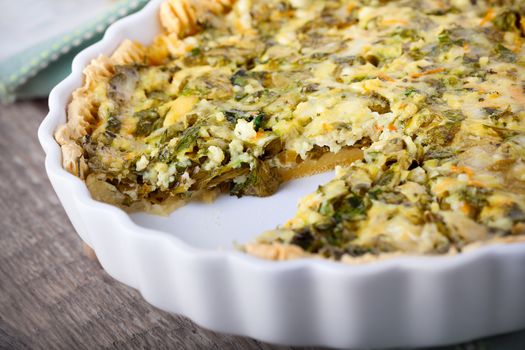 Spinache quiche, gluten free on a wooden surface